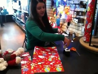 Folding a gift bag at Tree Town Toys