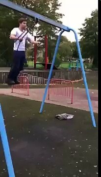 Banging his legs on the swing-