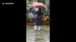 Woman shoos massive python from garden in flood-hit Kerala