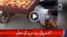 Boy washing apples with drainage water