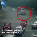 A car stalled at an intersection amid heavy rains. Watch how the vehicle was moved out of the way.
