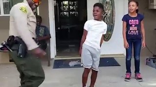 Police officer attempts to floss during dance-off with boy