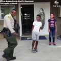 Police officer attempts to floss during dance-off with boy