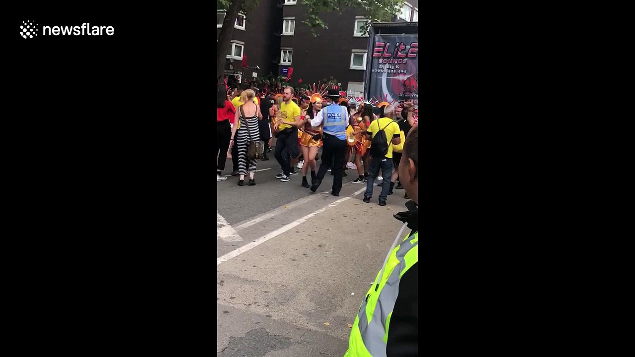 Dancing police officer takes a twirl at the Notting Hill Carnival