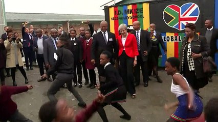 Theresa May dances with school children in South Africa