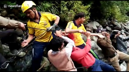 Rescue workers pull out horse from flooded river in Himalayas