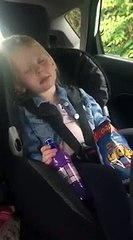 daughter sleep eating crisps in the car