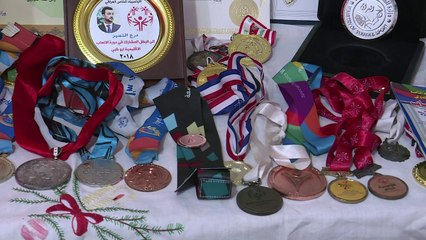 عراقيون يتجاوزون إصابتهم بمتلازمة داون ويرفعون علم بلادهم في المسابقات الدولية