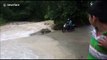 Moment man on motorbike is swept away in northern India floods