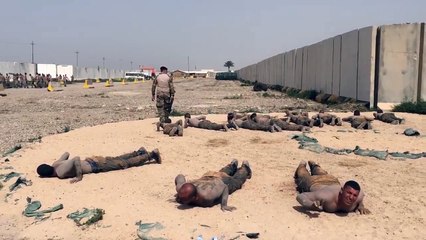 Extremely Soldier coaching in troop with captain shoot behind them