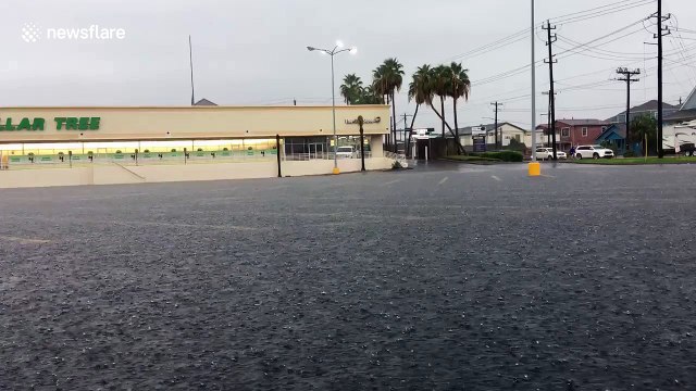 Heavy downpour floods parking lot in Galveston, Texas