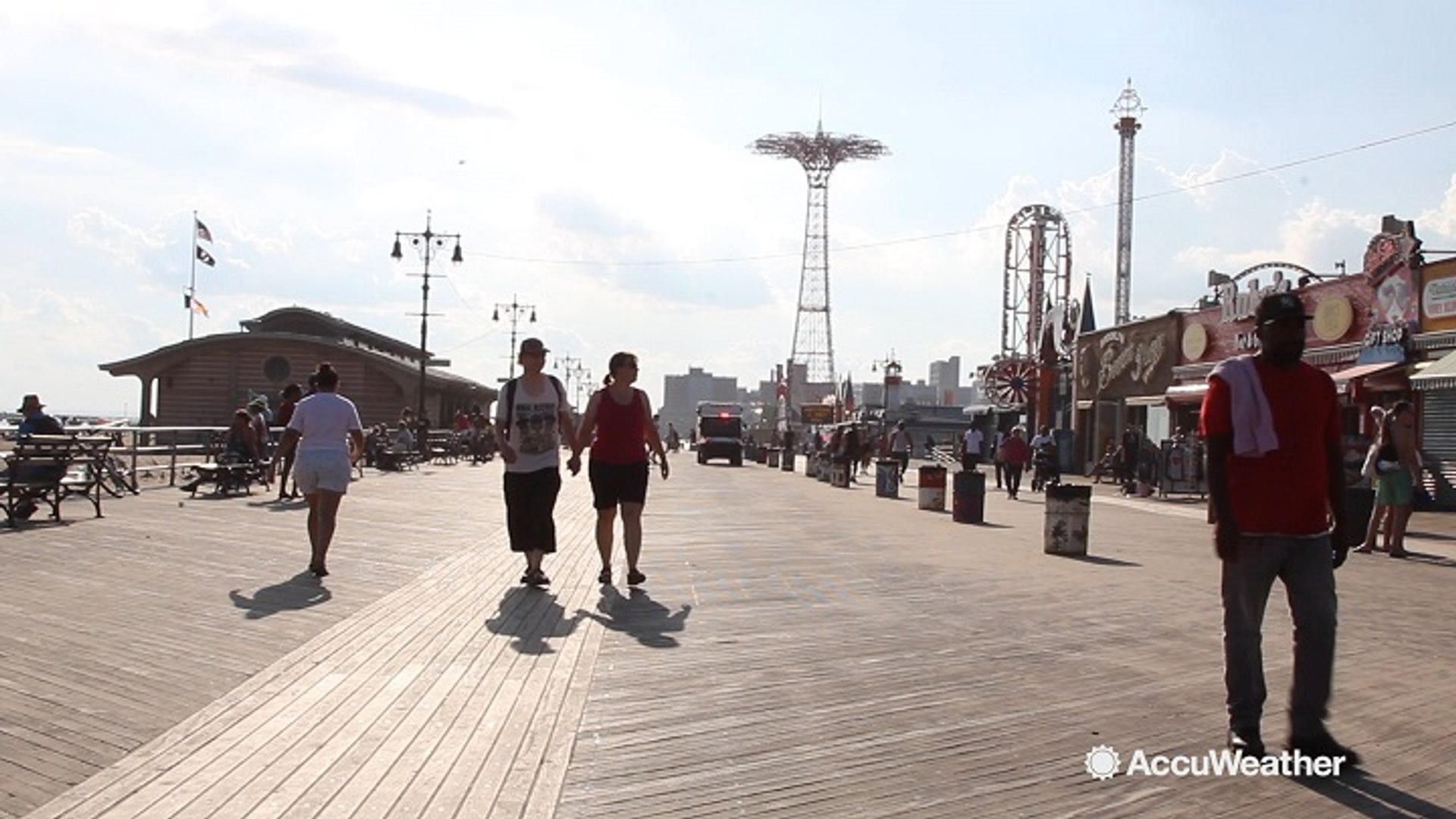 ⁣New Yorkers cool off at the Coney Island Boardwalk