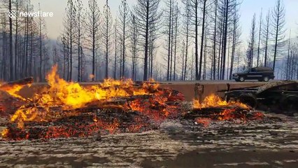 Video shows remains of vehicle debris burning on side of interstate as Delta Fire spreads