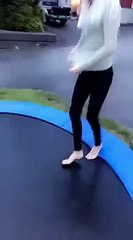 girl on a trampoline tries to somersault falls and ends up with her head under the cover
