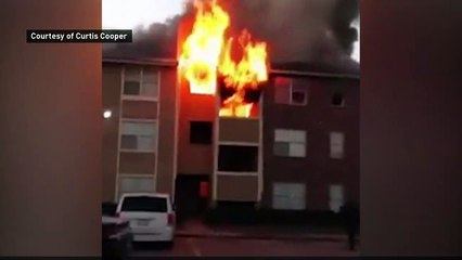 Woman drops baby from burning building