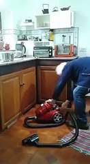 Old Man Trying To Start A Vacuum Cleaner The Wrong Way