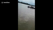 Shocking moment boat with 29 passengers sinks in flooded river