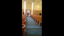 Kid dives onto bride's wedding dress as she walks down the aisle