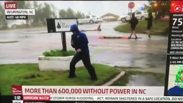 Weather Channel Reporter Is Caught Playing Up Hurricane As Two Men Casually Walk By