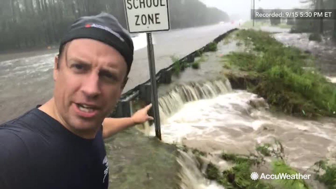 Reed Timmer at a road in danger of getting wash...