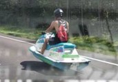 Driver Reacts With Astonishment to Jet Ski Moving on Land