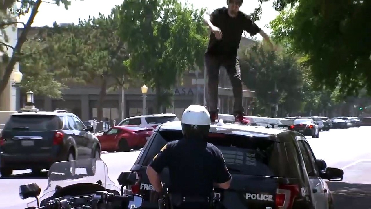 A man ransacks a police car but will soon regret it