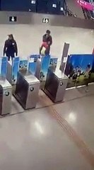 A drunk young man falls down the stairs of the metro