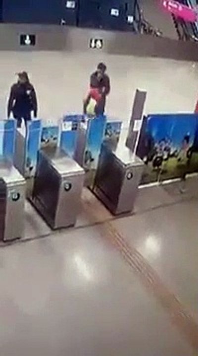 A drunk young man falls down the stairs of the metro