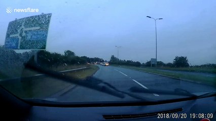 Cars drive around collapsed lamppost felled by Storm Ali winds