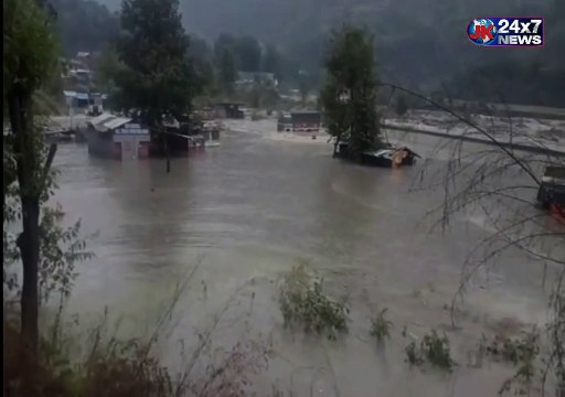 Vacant trucks gets washed away into the flooded Beas river in Manali HimachalPradesh