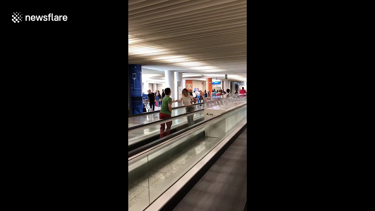 Couple beats flight delay with impromptu salsa performance on airport walkway