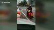 Motorcyclist tosses rubbish back into litterbug’s car
