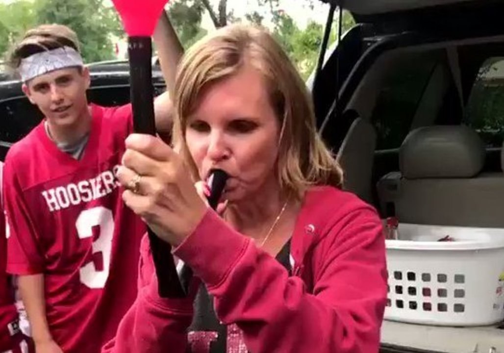 Mom at College Football Tailgate Hits Beer Bong While Her Husband Watches in Adoration