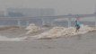 Surfers from around the world gather to ride tidal bores of the Qiantang River