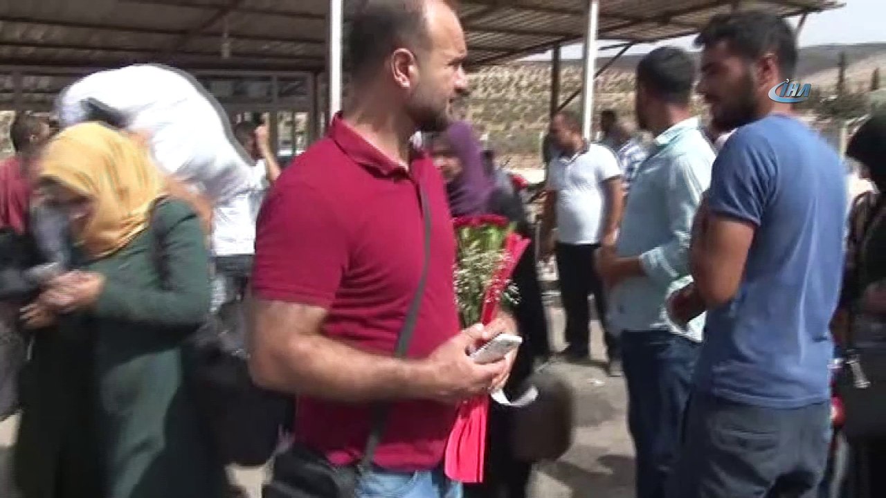 Üç yıldır görmediği ailesini elinde çiçekle bekliyor