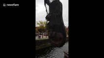 Giant sandal is suspended over Liverpool dock for festival