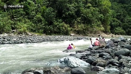 Daring teachers in Philippines float down rapids to reach their school