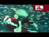 Santa Claus nada sobre un tiburón y da de comer a peces / Excélsior Informa con Andrea Newman