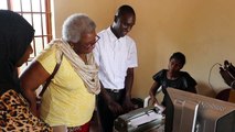 Mandela Washington Fellowship alumnus, Alieu Jaiteh, explains to Acting Public Affairs Officer Amelia Broderick how the braille machine works during the latter'