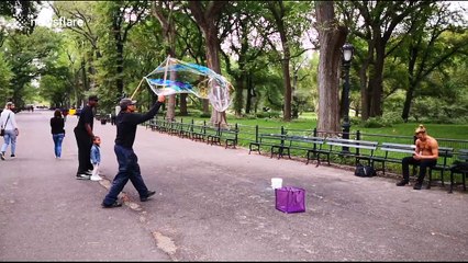 Slow motion footage of bubble man in Central Park, NY