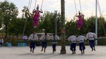 Swinging high and wide by spinning the pole, which is a game scaring you to be pale in Uyghur language, at the traditional games for ethnic groups in China's Xi