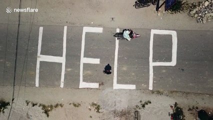 Indonesians chalk 'HELP' on ground as officials say search for victims to end