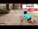 Three-year-old child plays with two snakes | SWNS TV