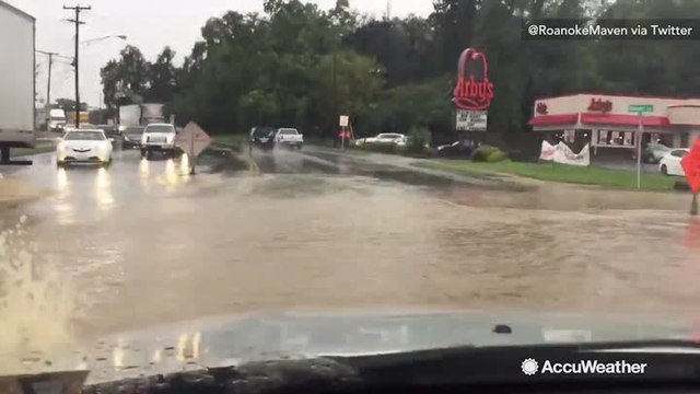 Woman captures high floodwaters covering a main roadway