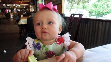 Adorable moment baby eats lemon for the first time