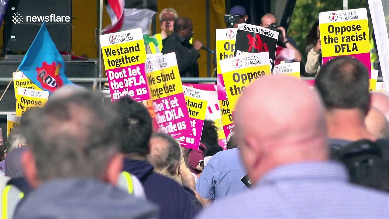 London police hold back hooligans attempting to reach anti-fascist protest