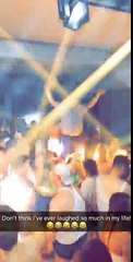 Older lad dances enthusiastically on a podium in the middle of a club