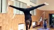 Girl Hula Hoops While Standing Upside Down on Thin Rope - 989678