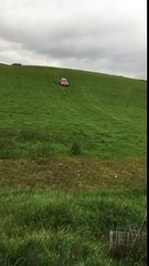 drives an old banger down a hill and jumps it over a bump