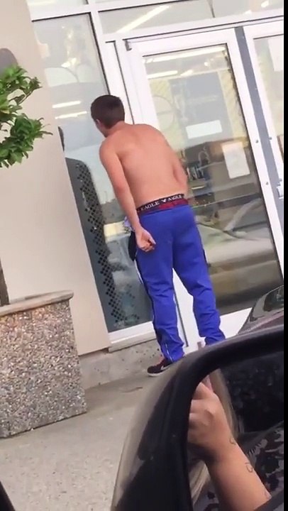flexing in the shop window to see his reflection